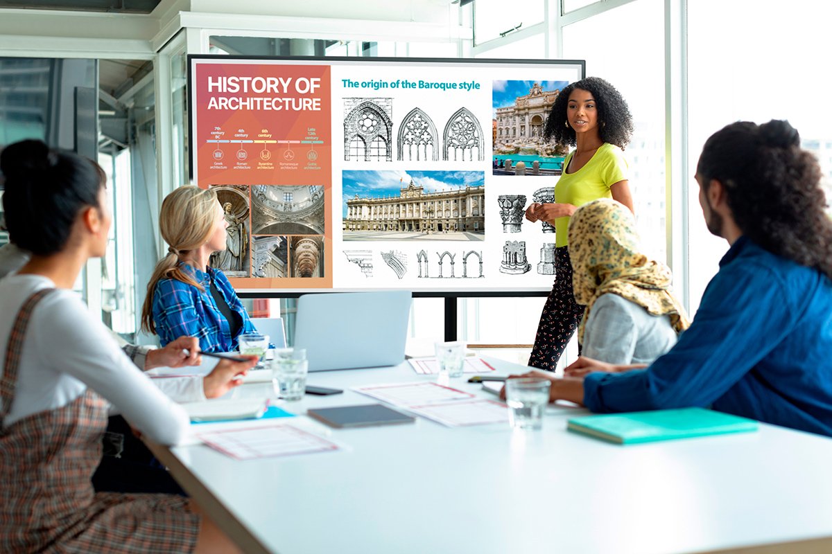 Front view of African-american businesswoman giving presentation on flip chart during meeting in a modern office